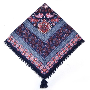 Detail of blue paisley floral square scarf featuring traditional knotted fringe edges