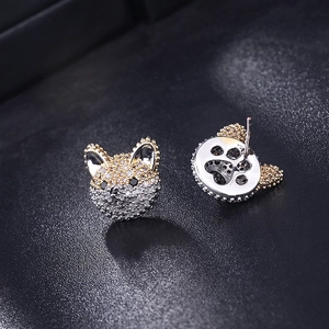 Detailed close-up of cute dog studs with multi-color zircons and paw print engraving
