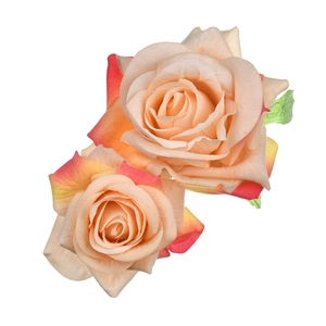 Close-up of dual pink and orange gradient fabric rose hair clips on white background