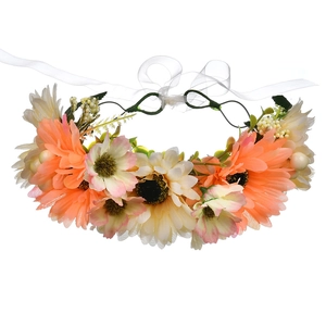 Detail of simulated orange and beige floral headband with silk ribbons for wedding hair