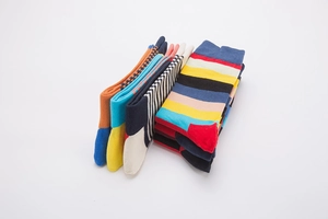 Detail view of colorful striped socks stacked to show vibrant patterns and cotton texture