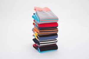 Stack of colorful striped cotton blend socks in multiple vibrant color combinations