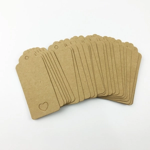Macro view of rectangular kraft paper tags with heart-shaped cutout and pre-punched holes
