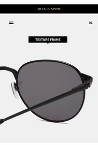 Detail showing the textured frame and precision hinge of these black oval sunglasses