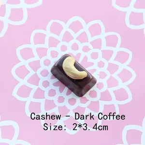 Macro detail of a 2x3.4cm cashew chocolate resin accessory for DIY keychain making