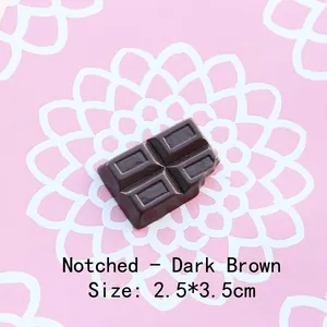 Macro shot of 2.5x3.5cm resin chocolate charm with bite mark detail on floral background