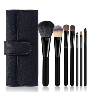 Professional 7-piece makeup brush set with elegant black leather roll case on white background