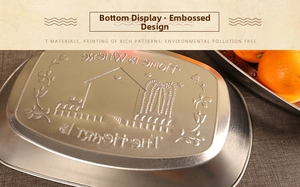 Detail of vintage silver metal tray with embossed HOME IS WHERE THE HEART IS text