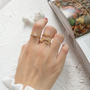 Vintage gold S925 silver ring set with rectangular zircon worn by model in artistic setting