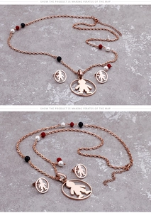 Detail of rose gold necklace and earrings with hollow child pendants and tricolor beads