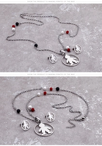 Detail of titanium steel jewelry set featuring boy charm pendants and colorful beads