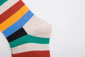 Close-up of fine knit texture and colorful striped pattern on the cotton socks