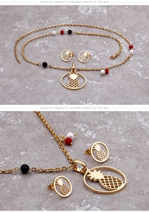 Macro view of gold pineapple pendant necklace and earrings set with colorful beads