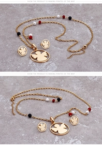 Detail of angel pendant necklace and stud earrings set with colorful beads in gold finish