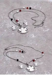 Detail of angel pendant jewelry set with tricolor beads and silver-tone finish