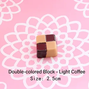 Macro shot of a 2.5cm two-tone resin chocolate square for DIY keychain making