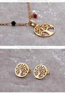 Close-up of golden Tree of Life jewelry set with red and black beads and faux pearl detail