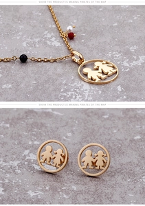 Detail of gold titanium steel necklace and earrings set with boy girl silhouette pendants