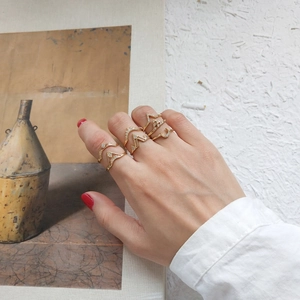 Detail of gold geometric rings set with moon and crown designs and micro-pave crystals