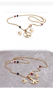 Detail view of gold peace sign jewelry set with dimensions and colorful beads