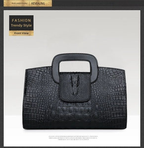 Front detail of black crocodile texture handbag with 3D metal crocodile head ornament