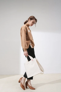 Fashionable striped canvas shoulder bag paired with brown loose hoodie for casual look