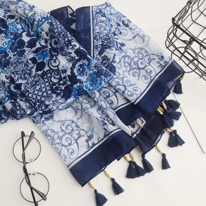 Close-up of navy blue tassels and wood beads on a bohemian porcelain print cotton scarf