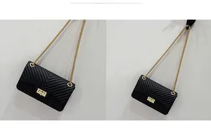 Macro detail of black V-pattern quilted crossbody bag with golden chain and metal lock