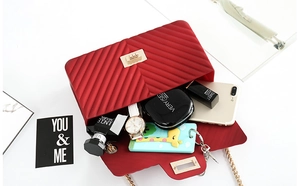 Internal view of red matte jelly bag showing storage capacity for phone and cosmetics