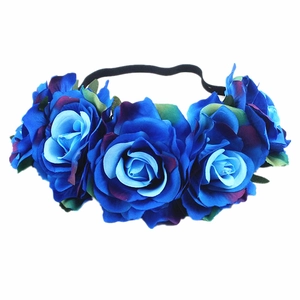 Detail of blue artificial rose headband with green leaves and black elastic band