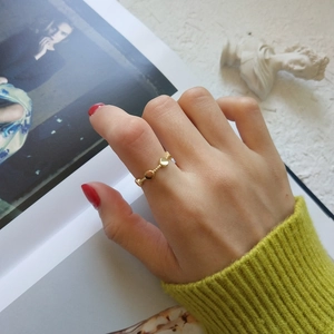 Minimalist S925 sterling silver golden ring with textured round disc charms on a model