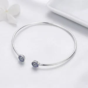 S925 sterling silver open bangle featuring sparkling evil eye charms with blue crystals