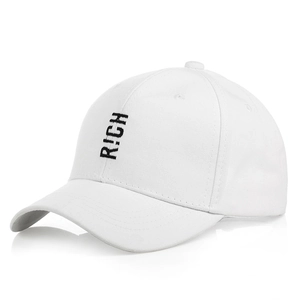 Detailed view of R!CH embroidery on white cotton baseball cap with twill texture