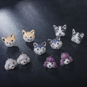 Detailed close-up of cute dog earrings with sparkling cubic zirconia in various vibrant colors