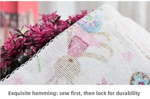Detail view of fine overlock stitching on floral linen drawstring bag edge