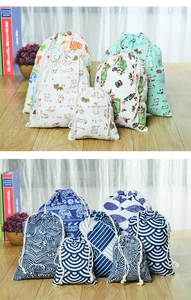 Detail of printed cotton linen drawstring storage bags with cat and wave patterns