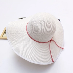 White wide brim straw sun hat with pink ribbon for summer beach vacation and outdoor sun protection