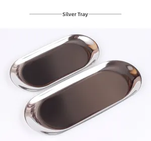 Macro shot of polished silver stainless steel oval trays with mirrored finish surfaces