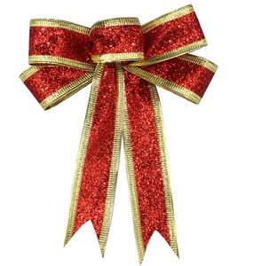 Detail of red glitter Christmas bow with gold trim and sequins on a white background