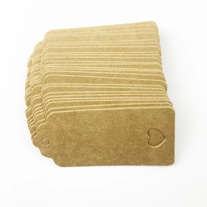 Detail of rectangular brown kraft paper tags with round holes and heart shaped cutouts