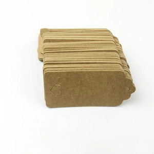 Macro detail of brown kraft paper tags featuring a hollow heart and pre-punched hole