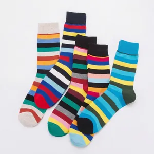 Four pairs of colorful striped cotton blend mid-calf socks laid flat on white background