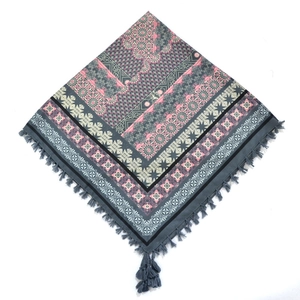 Detailed view of bohemian square scarf with ethnic geometric prints and grey fringe tassels