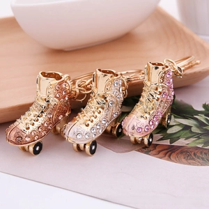 Detailed view of colorful rhinestone-encrusted roller skate keychains in gold finish