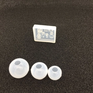 Detailed macro view of multi-slot silicone resin mold with finished spheres for DIY jewelry