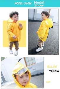 Detail of yellow dinosaur raincoat with transparent hood visor and spiky 3D back detail