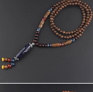 Detailed view of ethnic wood bead necklace with star-patterned pendant and colorful tassels