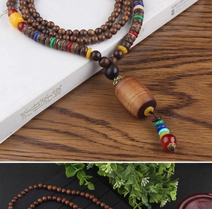 Close-up of ethnic style wooden prayer beads necklace with colorful spacer accents