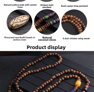 Detail view of ethnic wood bead necklace featuring bodhi seeds and resin pendant accents