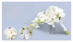 Detail of white calla lily bridal bouquet handle with lace ribbon and satin bow